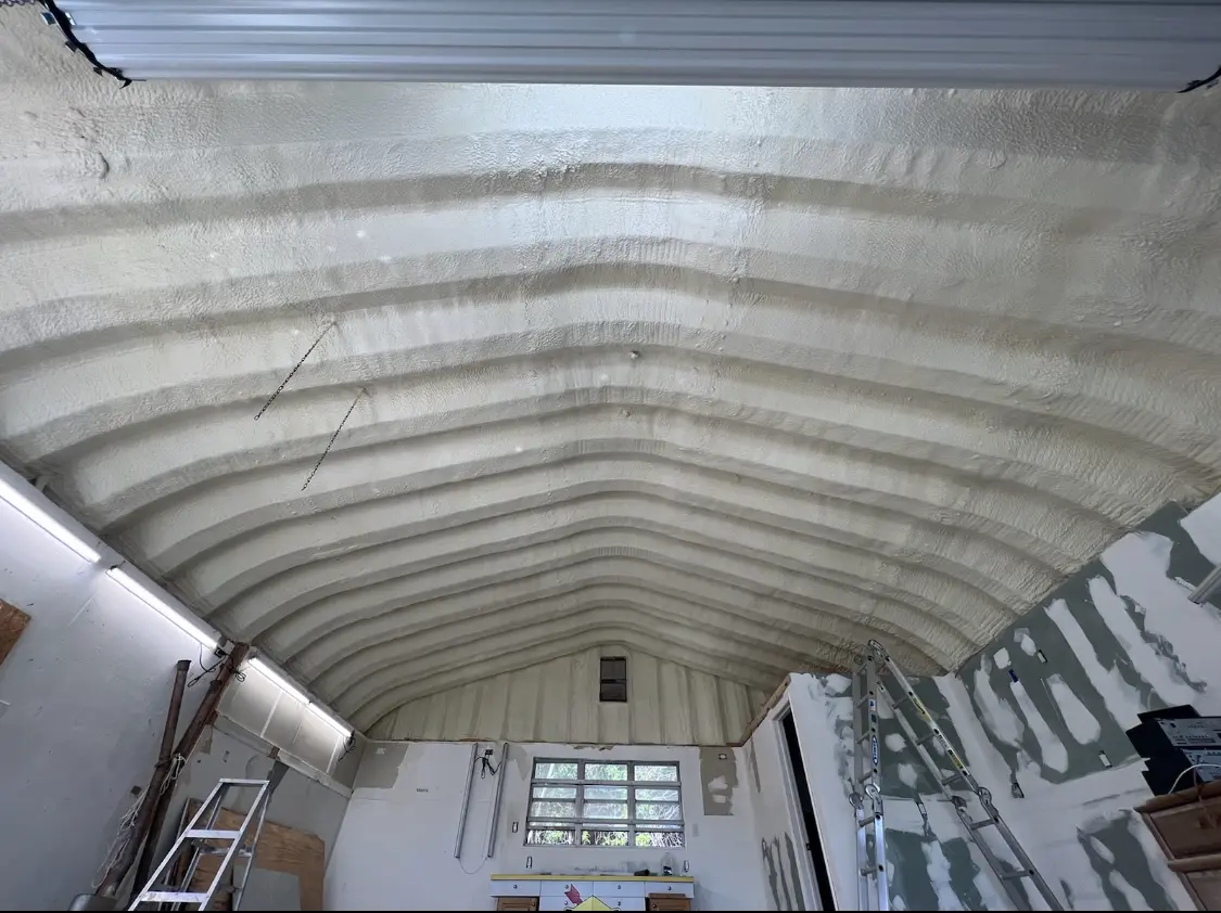 Spray polyurethane foam applied to the underside of a metal roof deck in Blair
